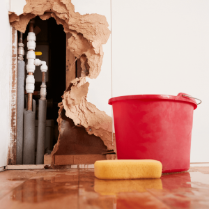 Leaking water line pipe inside bathroom wall being fix by a professional 24 hour emergency pipe fitter